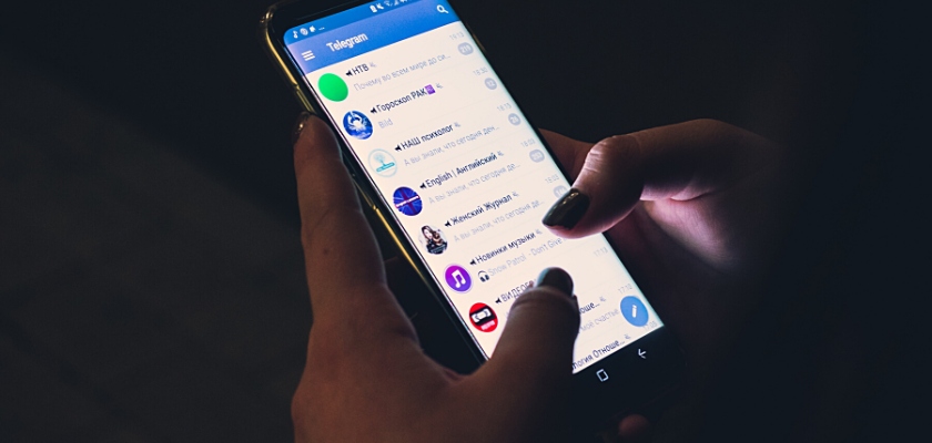 Vista parziale di una ragazza mentre sta cercando un profilo Telegram dall’App del suo iPhone